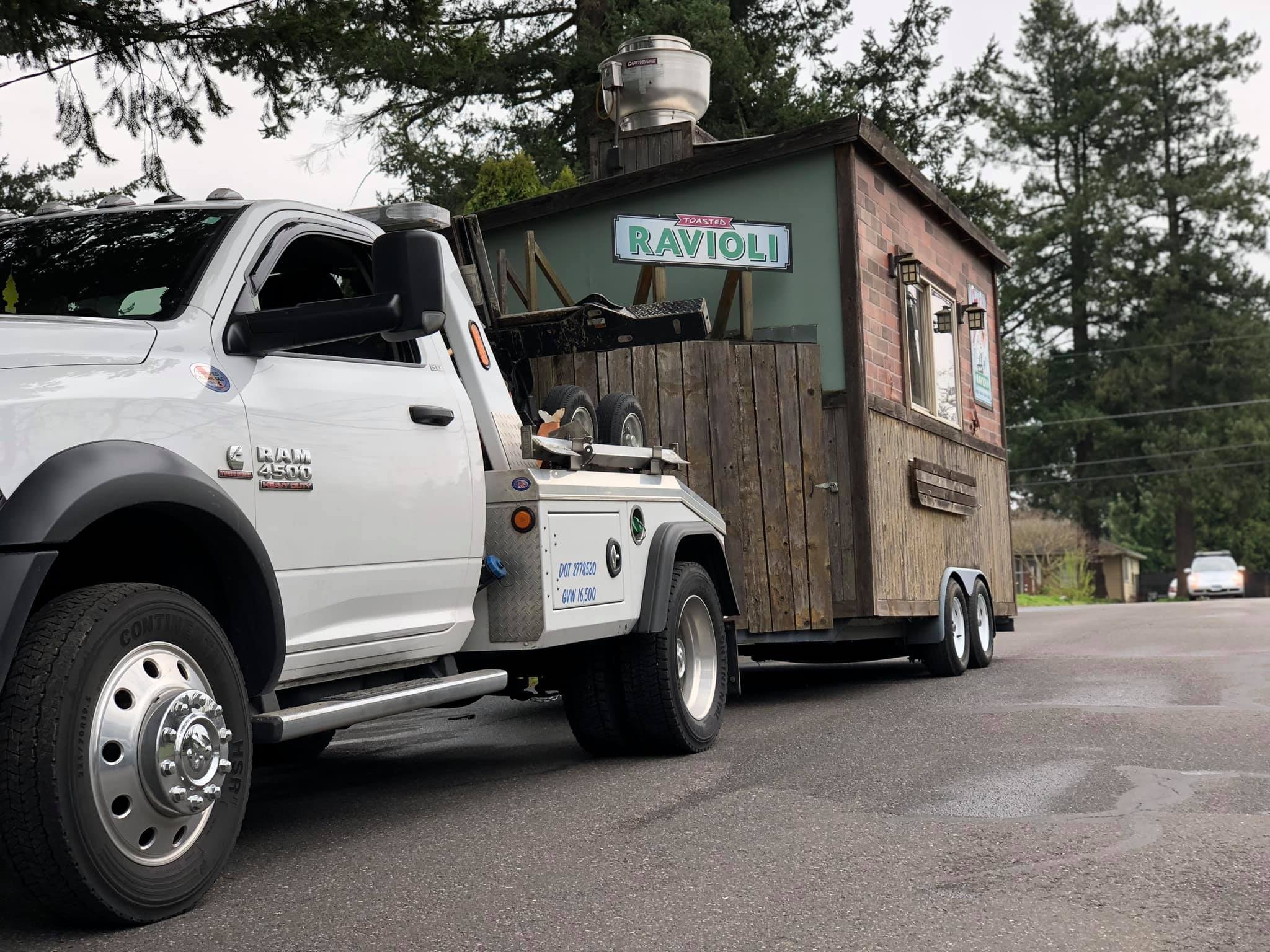 Elite Towing truck towing a food cart