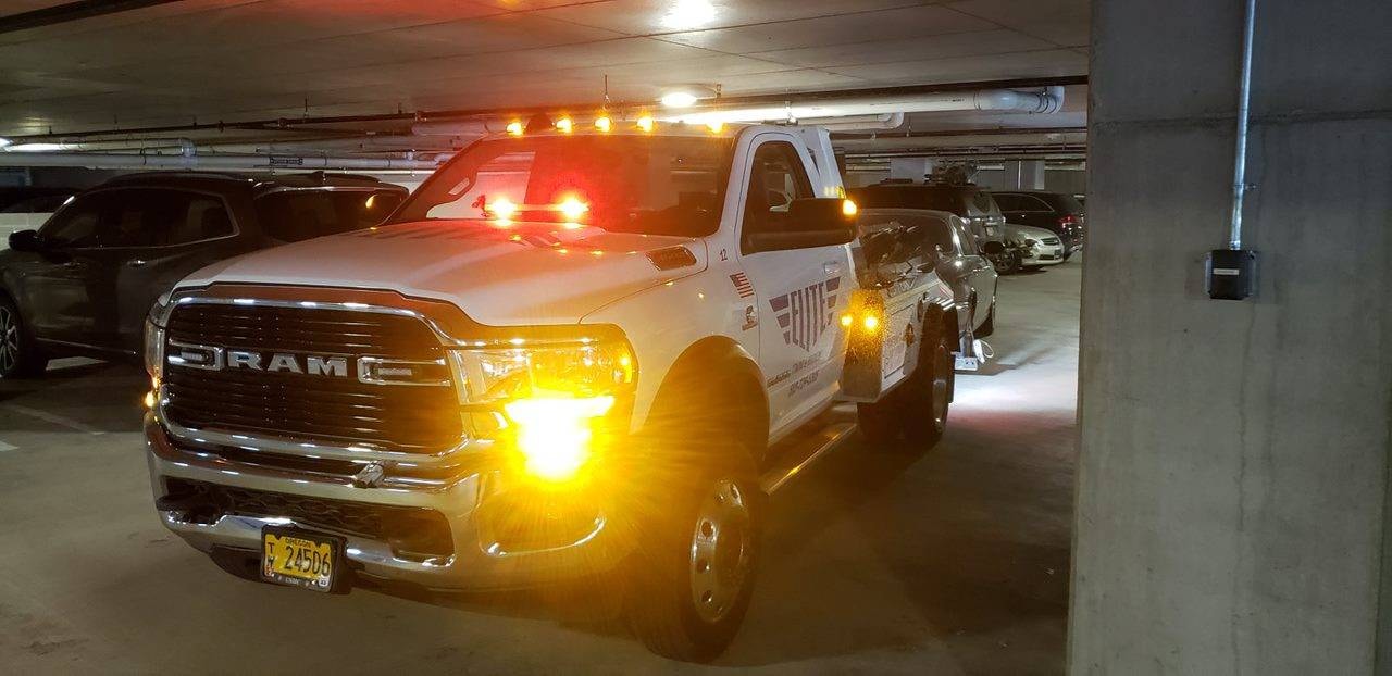 Elite Towing truck in parking garage at night